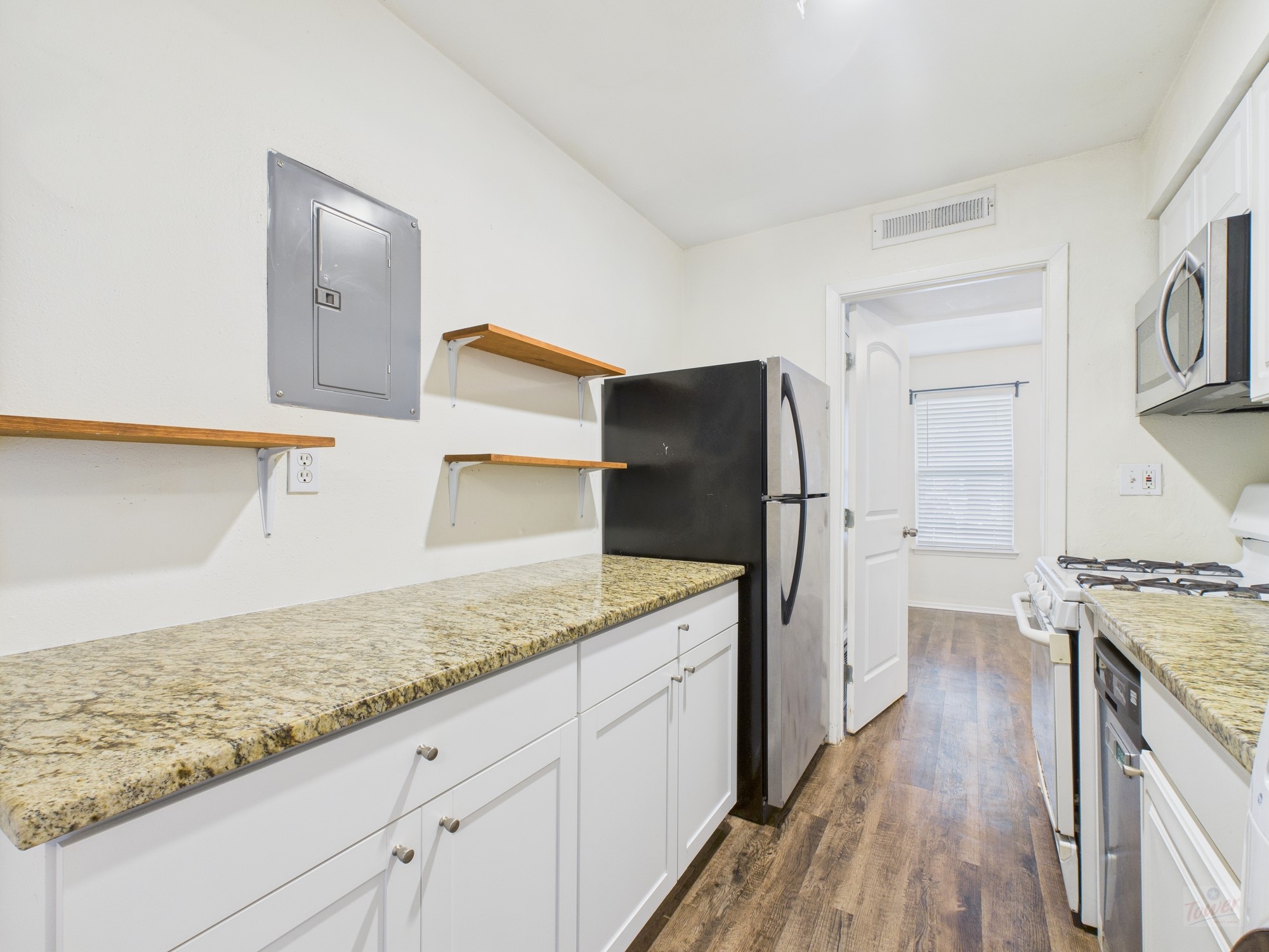 1106 West 22nd Street, Unit 5 Austin, TX 78705 - Photo 2 of 13 a kitchen with a sink stove and refrigerator