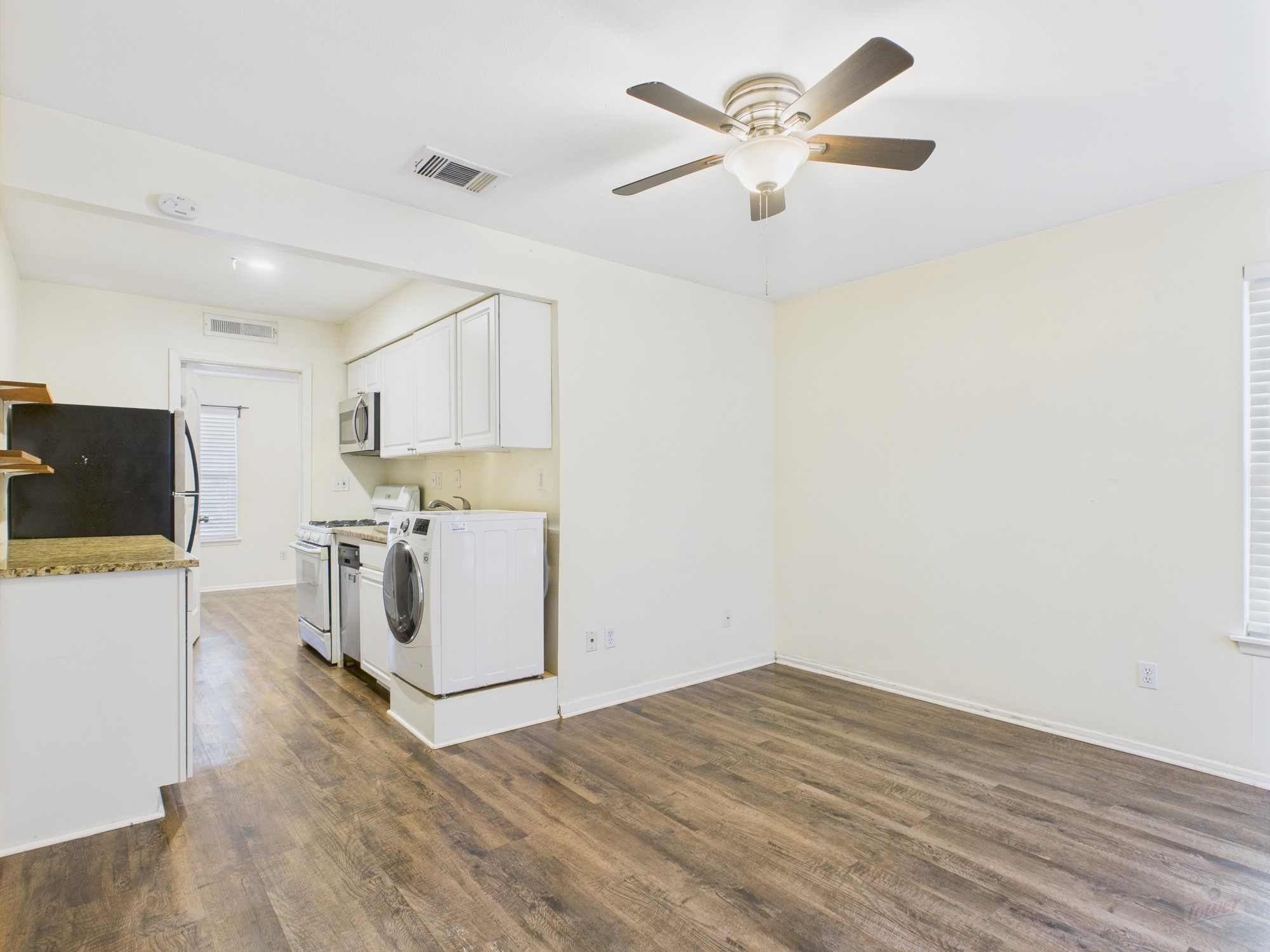 1106 West 22nd Street, Unit 5 Austin, TX 78705 - Photo 4 of 13 a view of a workspace with wooden floor and a ceiling fan