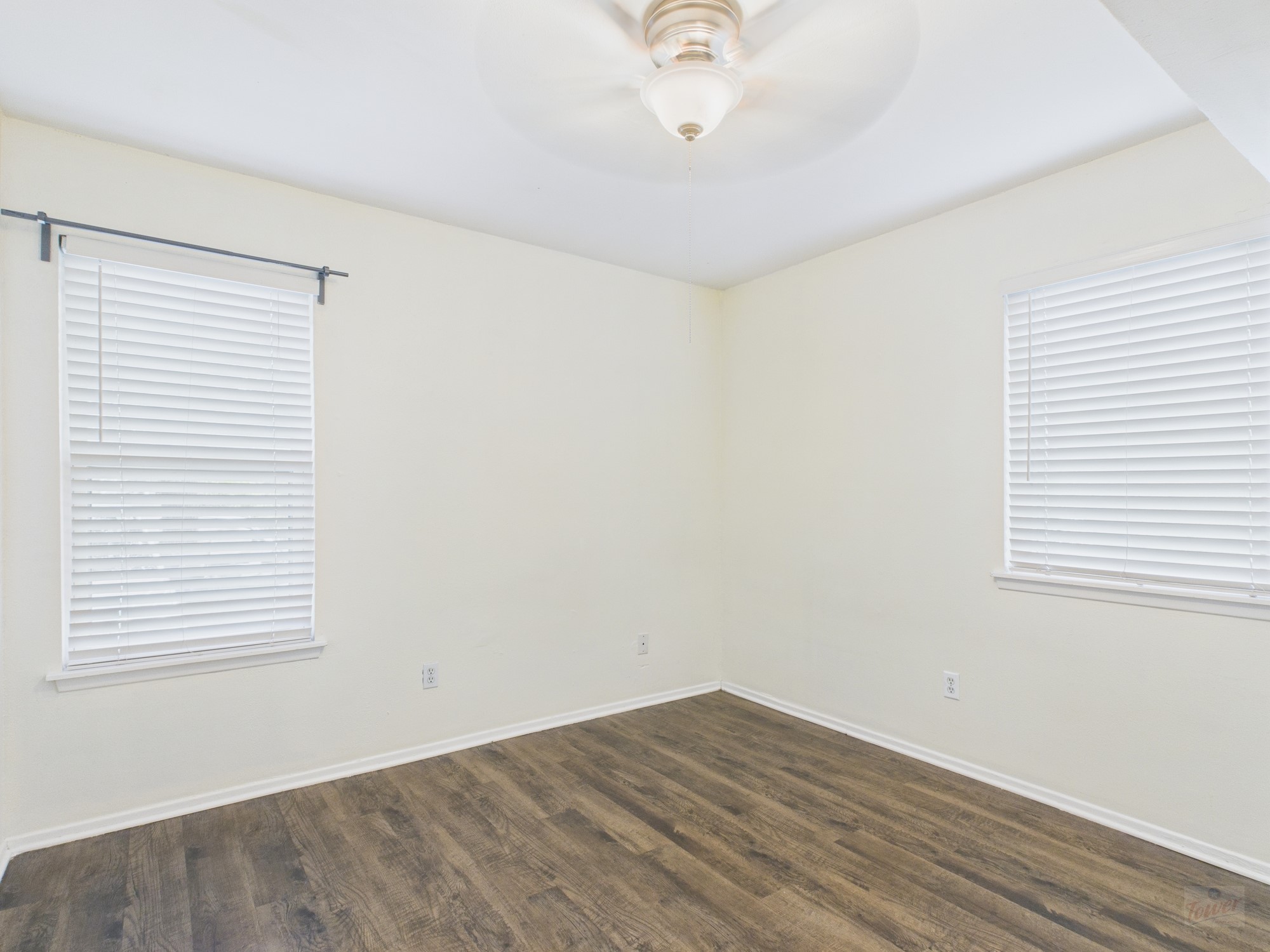 1106 West 22nd Street, Unit 5 Austin, TX 78705 - Photo 9 of 13 an empty room with wooden floor and windows