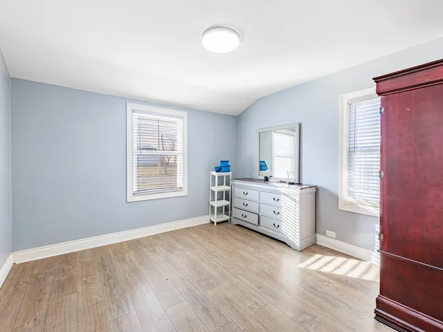wooden floor with white walls and window