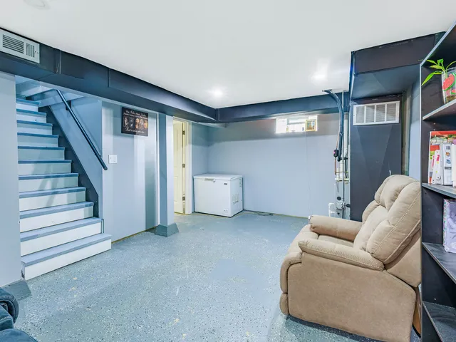 a living room with furniture and a walk in closet