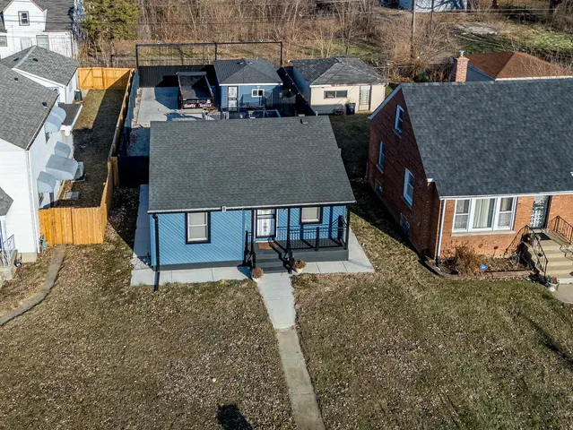 an aerial view of a house with a yard