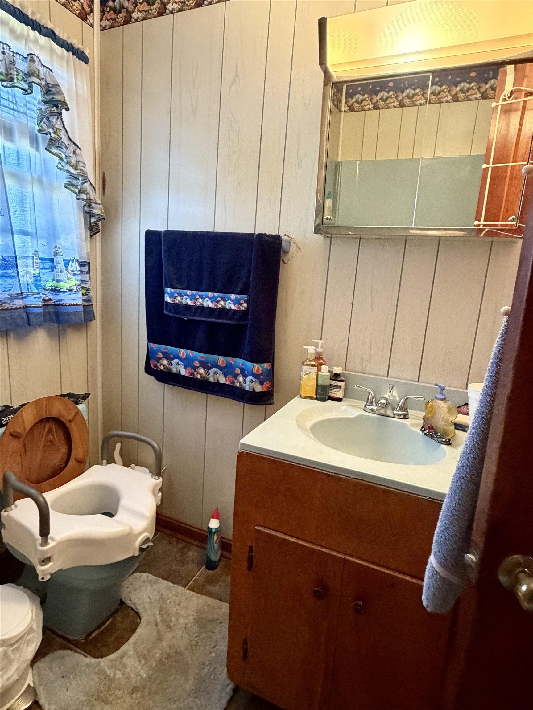 218 Sardie Henry Road Bethel Springs, TN 38315 - Photo 12 of 18 Bathroom with vanity and wood walls