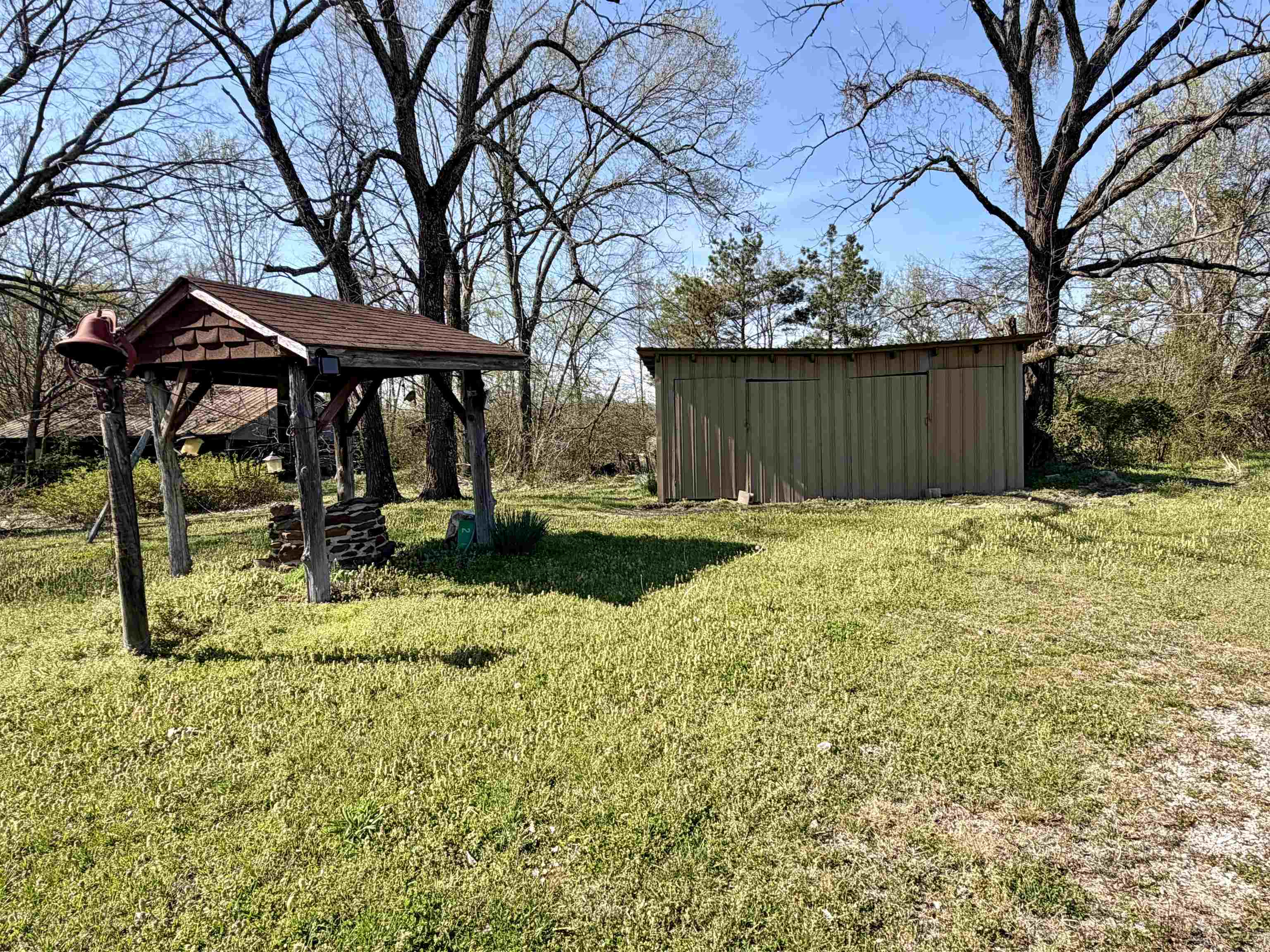 218 Sardie Henry Road Bethel Springs, TN 38315 - Photo 16 of 18 View of green lawn featuring a storage shed