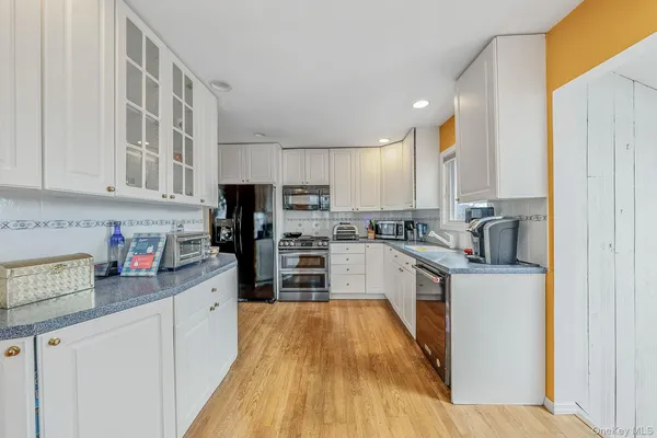 a kitchen with stainless steel appliances a refrigerator sink and cabinets