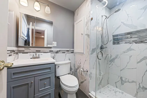 a bathroom with a sink toilet and shower