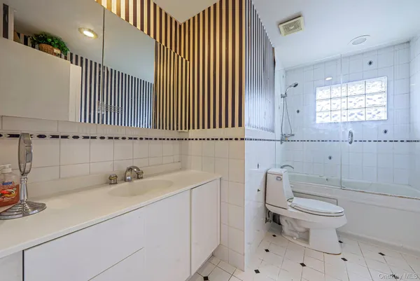 a bathroom with a sink a toilet and a window