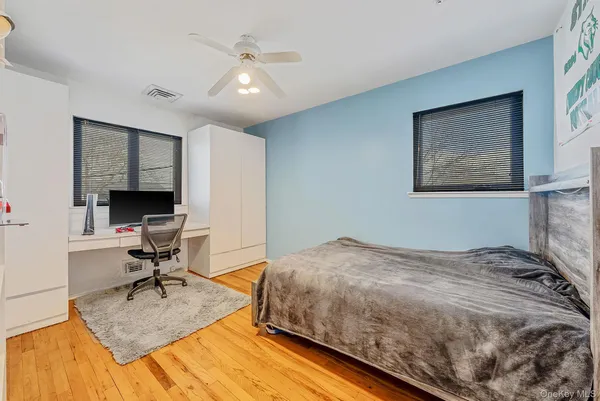 a bedroom that has a bed and a chair in it