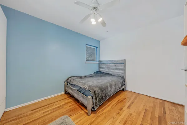 a bedroom with a bed and a ceiling fan