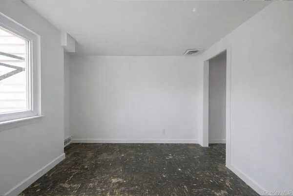 an empty room with a empty space and windows