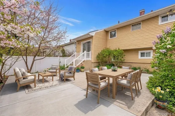 a view of a house with patio and a yard