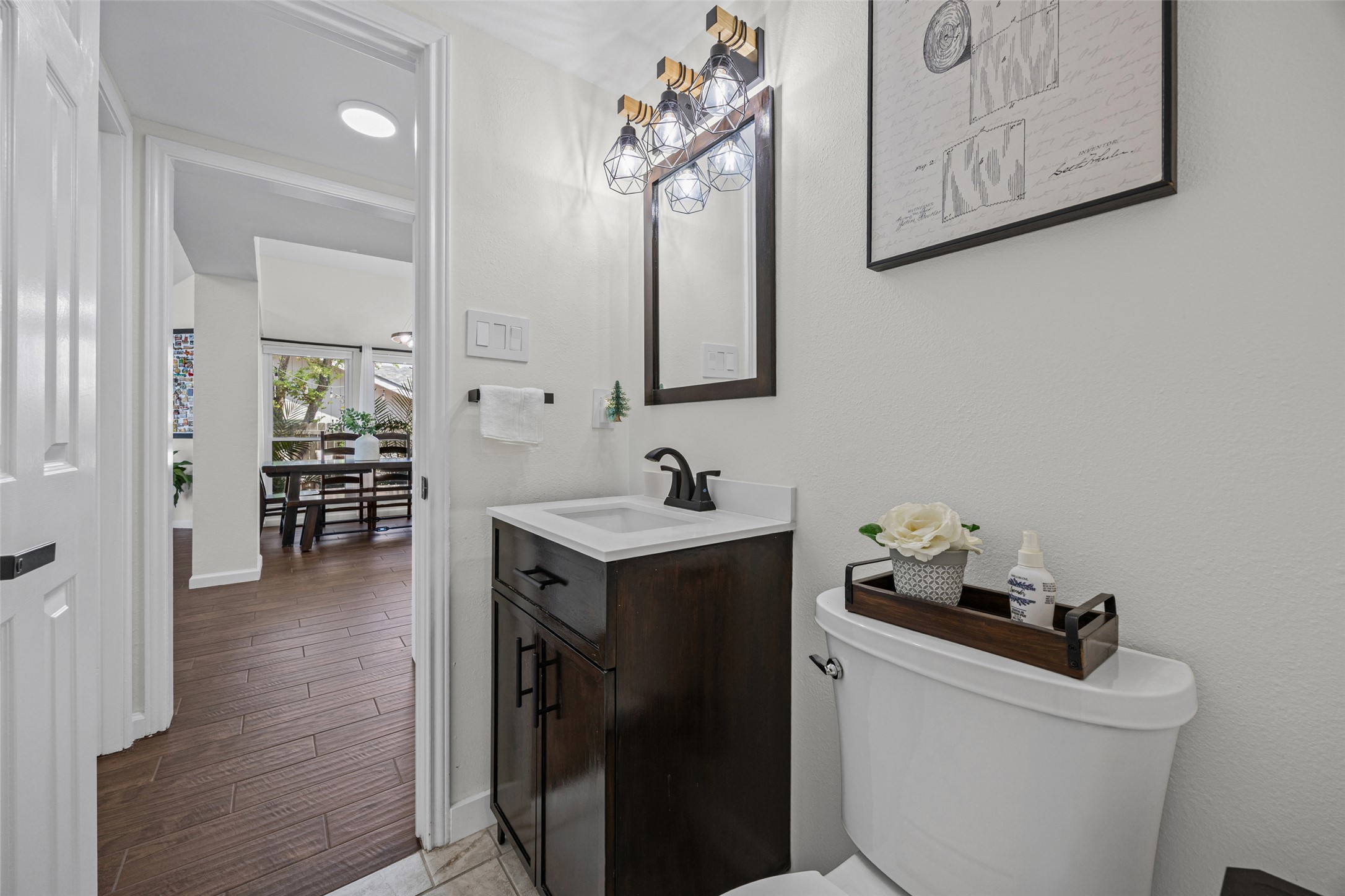 3006 Overland Street Round Rock, TX 78681 - Photo 19 of 29 A modern vanity with a dark wood cabinet anchors this beautifully updated powder room.