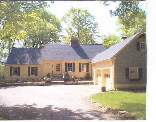 61 Rising Ridge Road Ridgefield, CT 06877 - Photo 1 of 1 a front view of a house with a yard