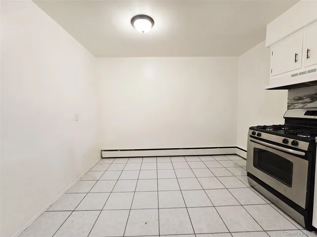 a view of a kitchen with white cabinets