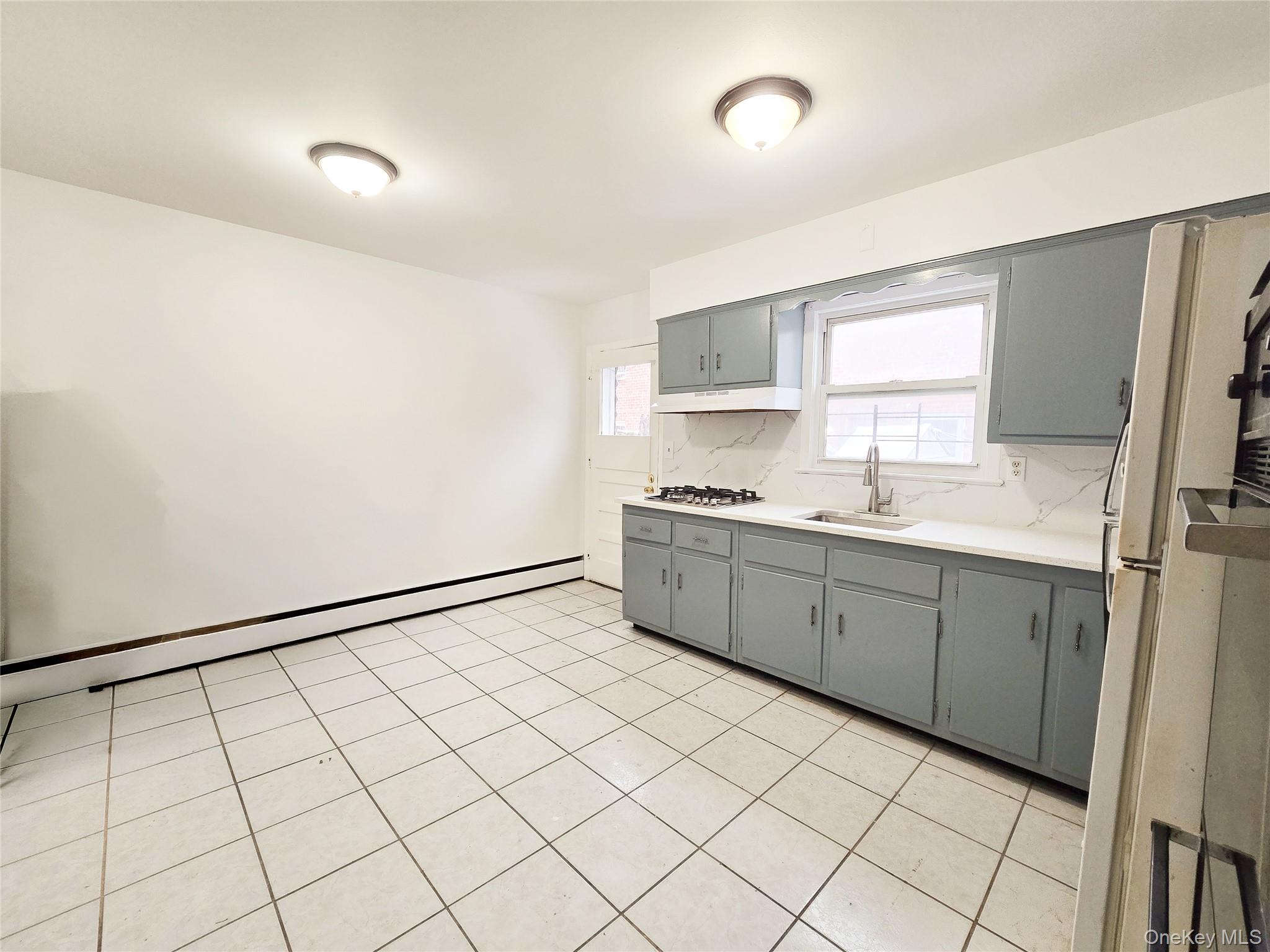 95-32 95th Street Queens, NY 11416 - Photo 16 of 20 a kitchen with a cabinets and white appliances