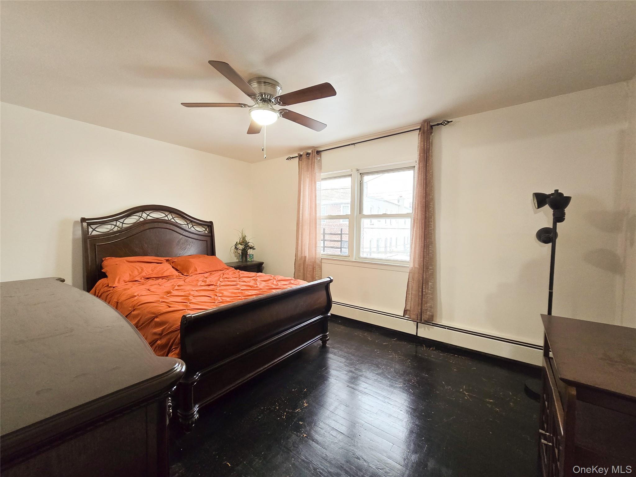 95-32 95th Street Queens, NY 11416 - Photo 2 of 20 a bedroom with a bed and wooden floor