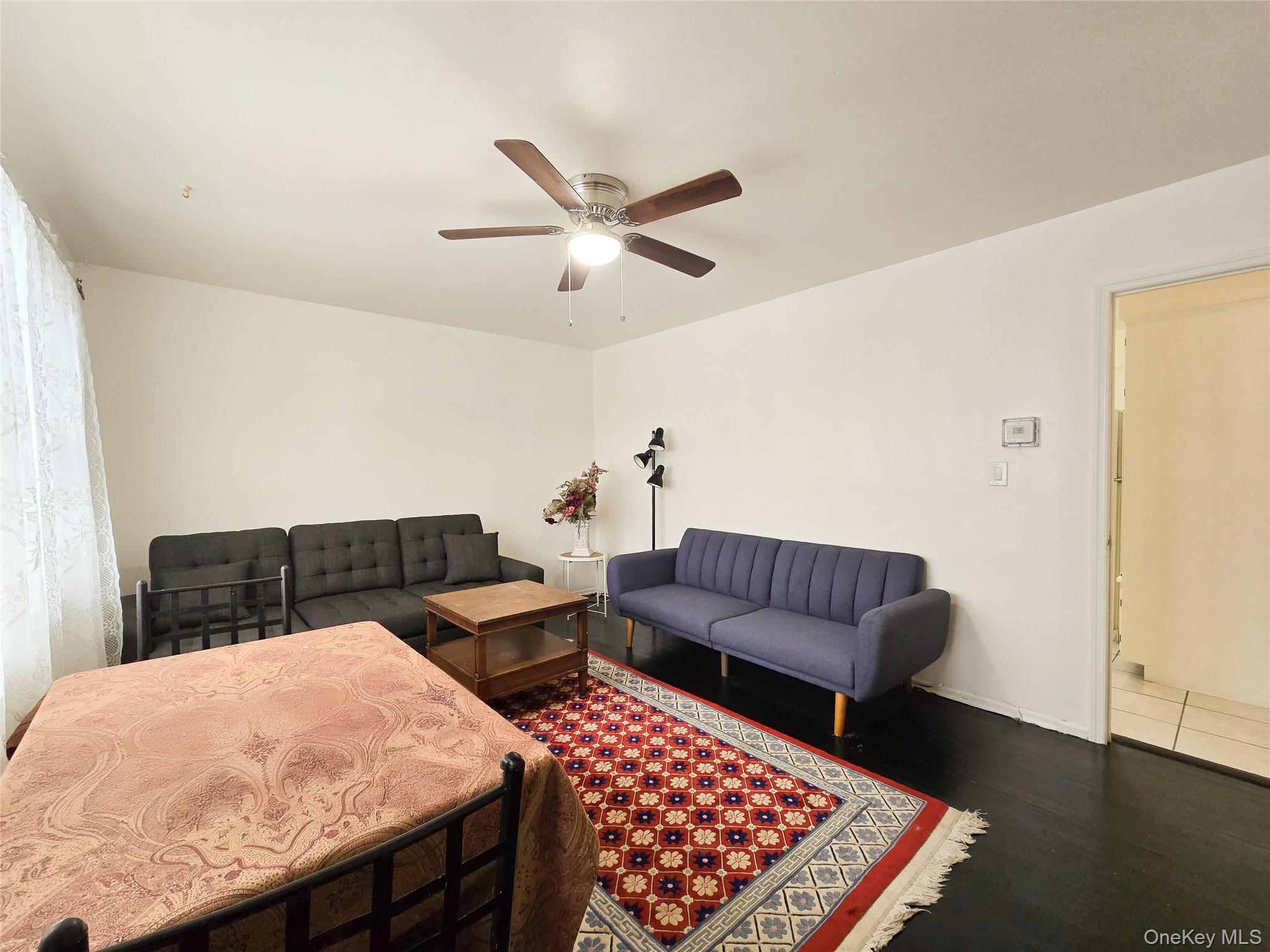 95-32 95th Street Queens, NY 11416 - Photo 3 of 20 a living room with furniture and a rug