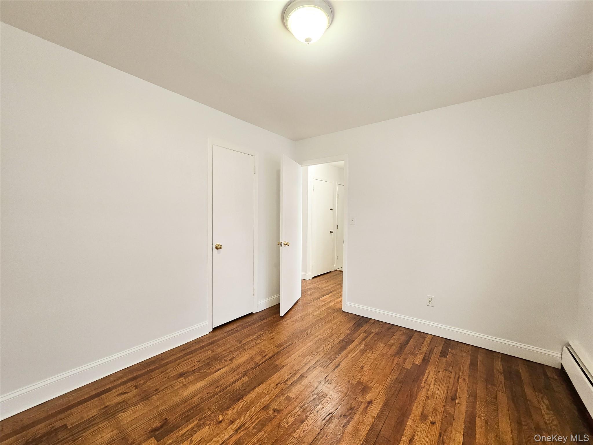 95-32 95th Street Queens, NY 11416 - Photo 9 of 20 a view of an empty room with wooden floor