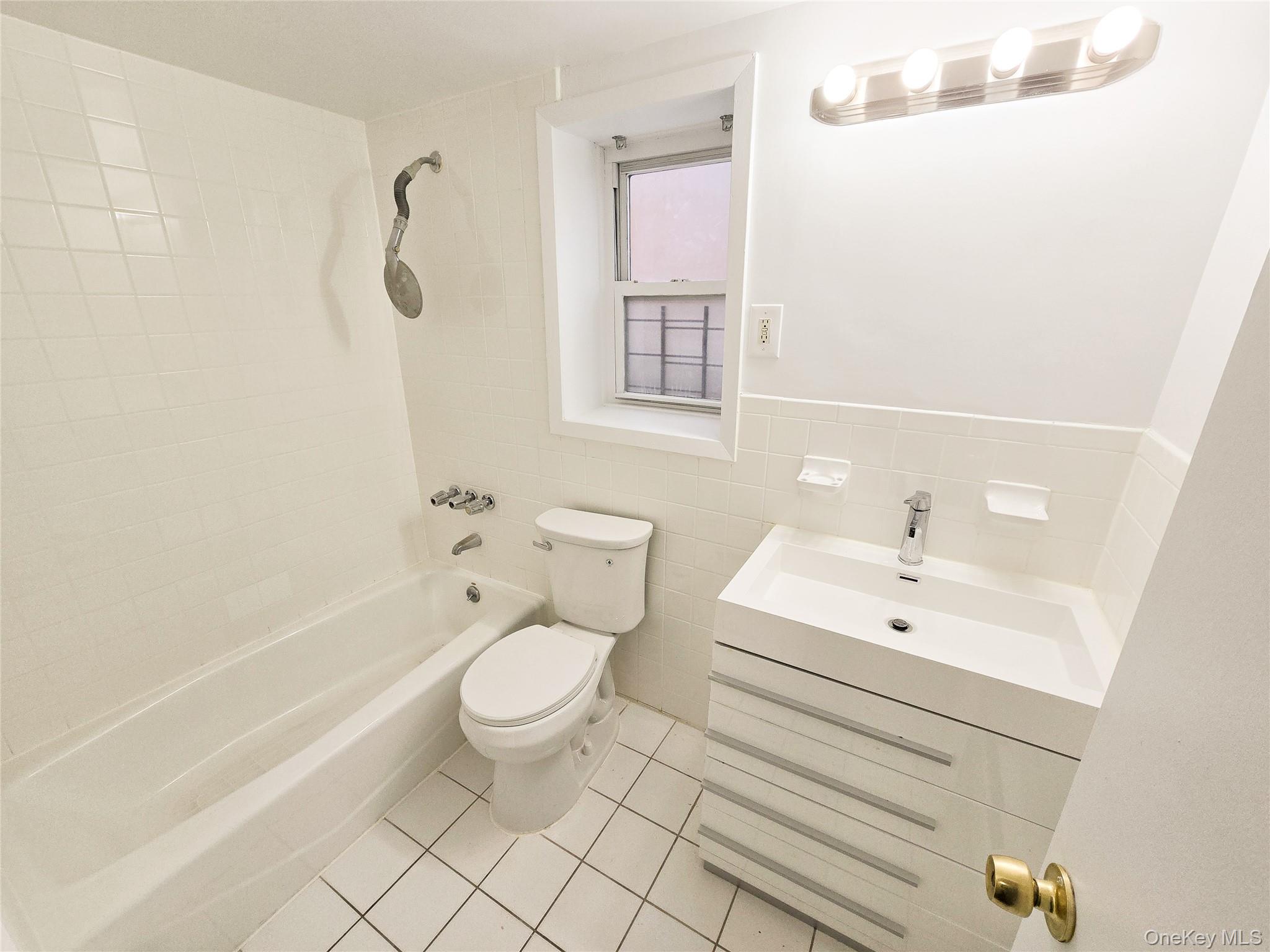 95-32 95th Street Queens, NY 11416 - Photo 10 of 20 a bathroom with a sink a toilet and shower