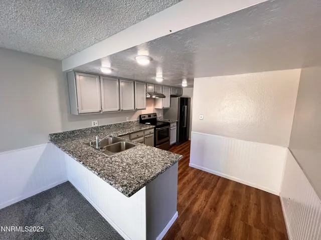 a kitchen with a sink stove and refrigerator