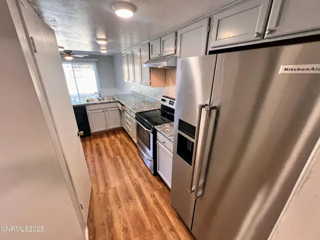 a kitchen with a refrigerator a sink and dishwasher