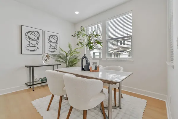 a view of a dining room with furniture and a potted plant