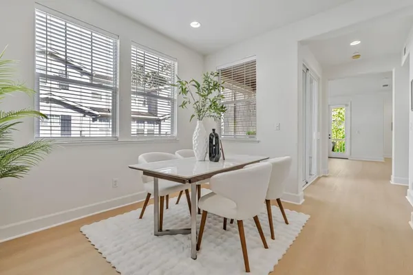 a view of a dining room with furniture and a potted plant