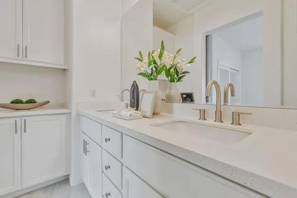 a bathroom with a sink a vanity and a mirror