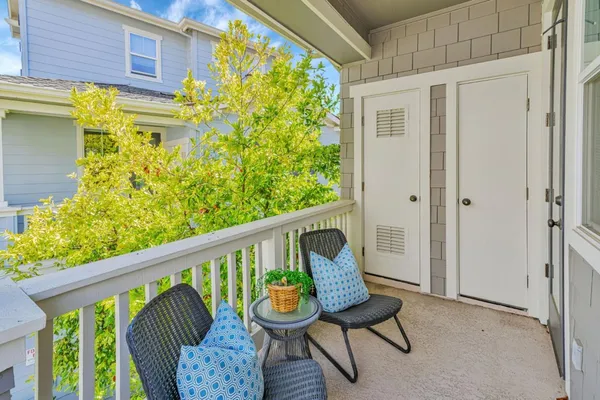 a balcony view with a seating space
