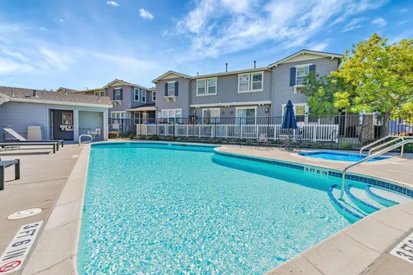 a house view with swimming pool and sitting space
