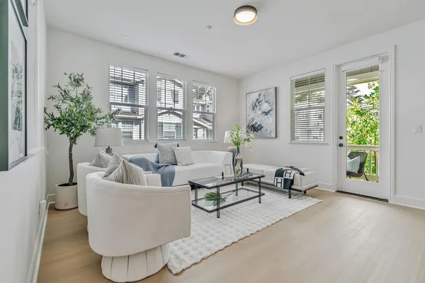 a living room with furniture and a large window