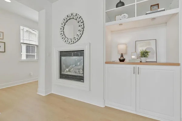 a view of room with window and wooden floor