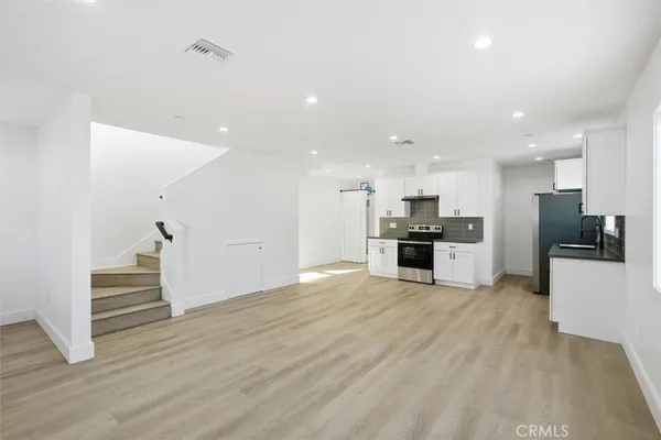 a view of kitchen with wooden floor and electronic appliances