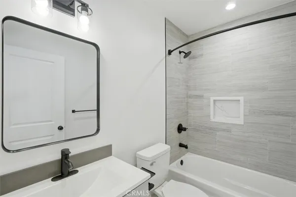 a bathroom with a sink a toilet and a bathtub