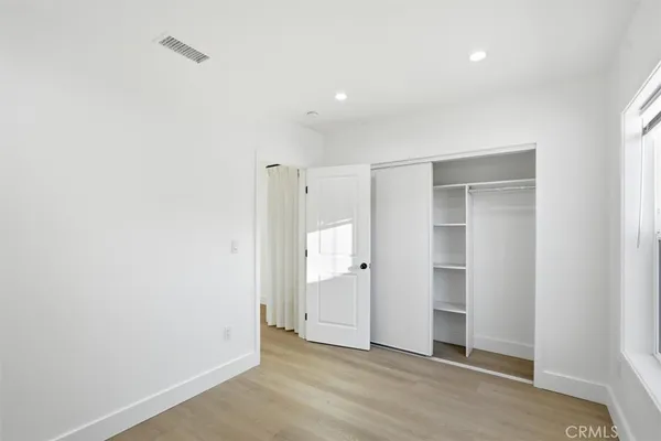 a view of an empty room with closet area