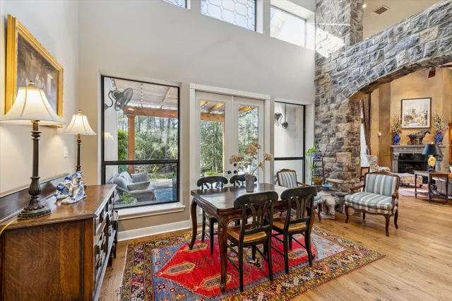 a dining room with furniture water view and large windows