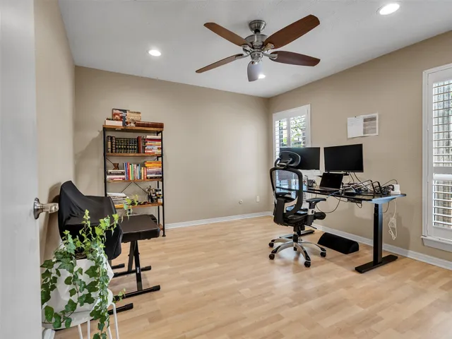 a view of a workspace with furniture and a window