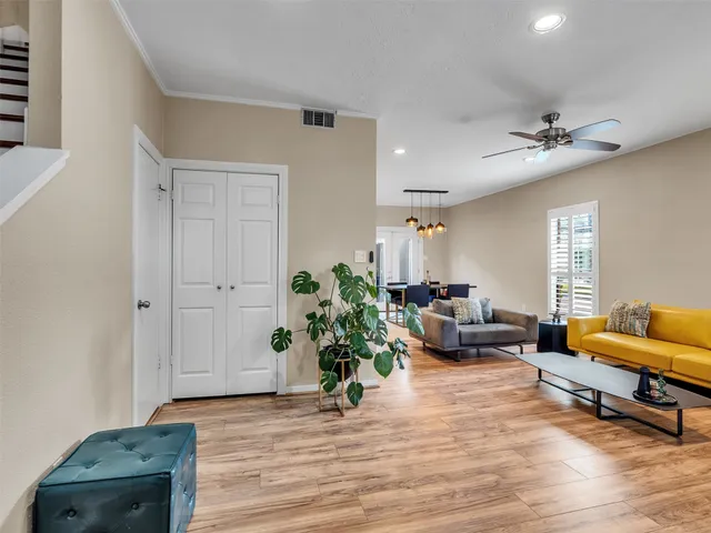 a living room with furniture and wooden floor