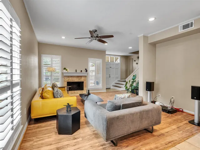 a living room with furniture fireplace and a large window