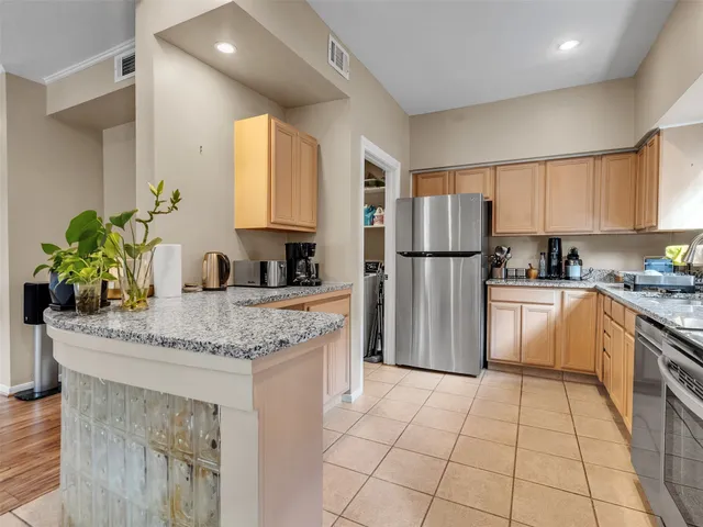 a kitchen with a stove a refrigerator and a sink