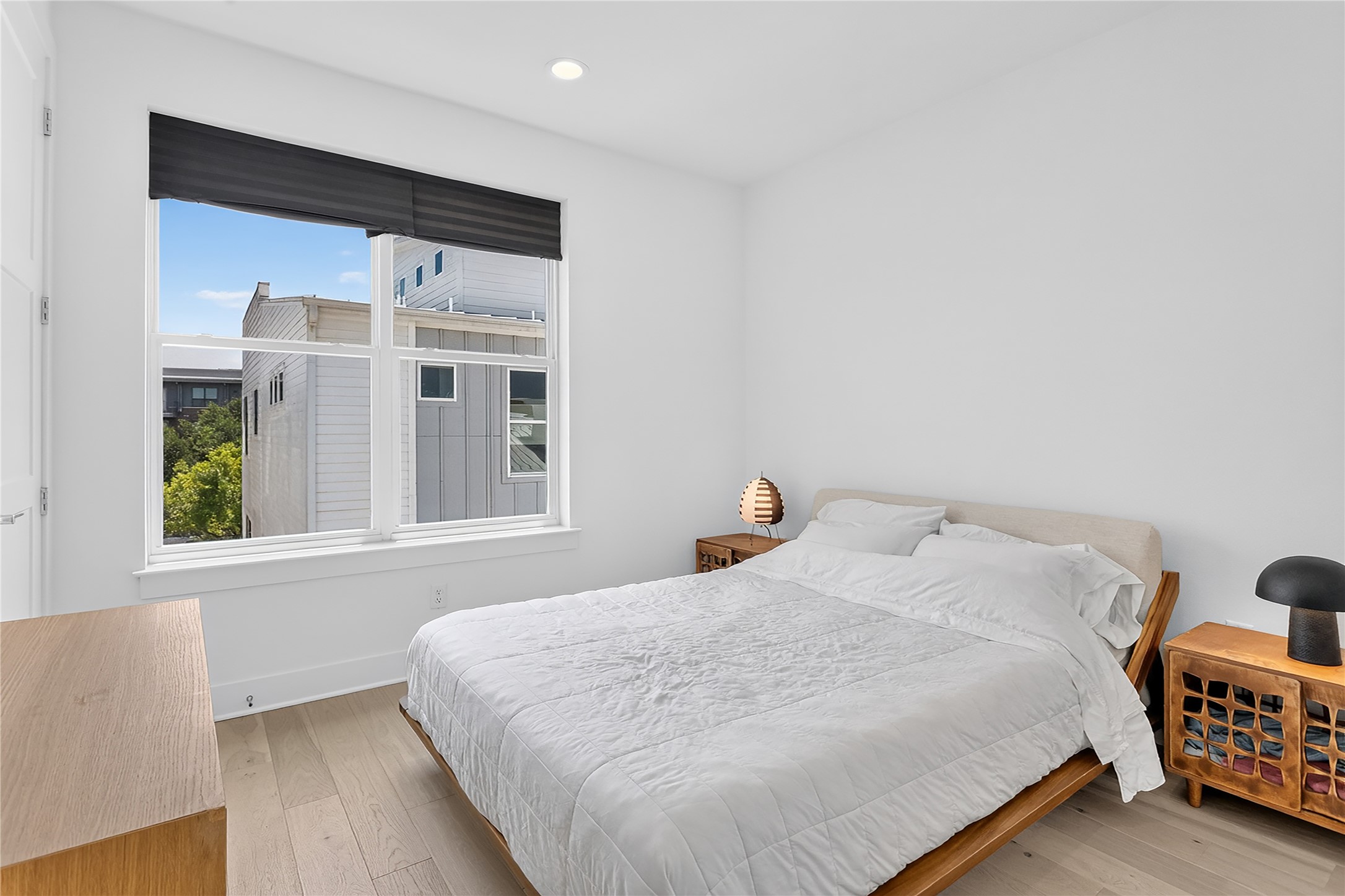 2805 McCurdy Street, Unit 14 Austin, TX 78723 - Photo 18 of 40 Bright and airy, this bedroom provides a tranquil retreat with wide plank hardwood floors and a large window overlooking the neighborhood.