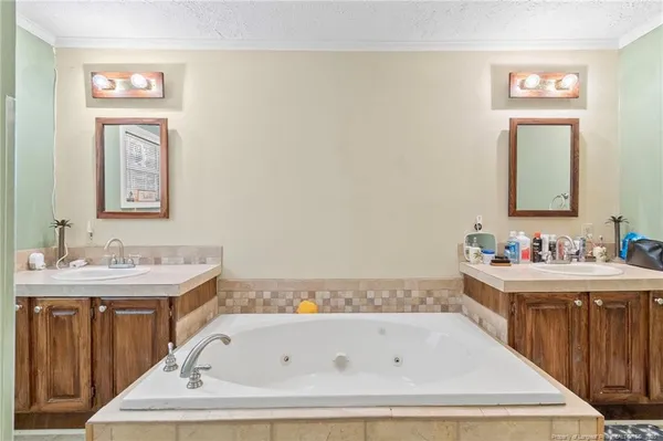 a bathroom with a bathtub sink and mirror