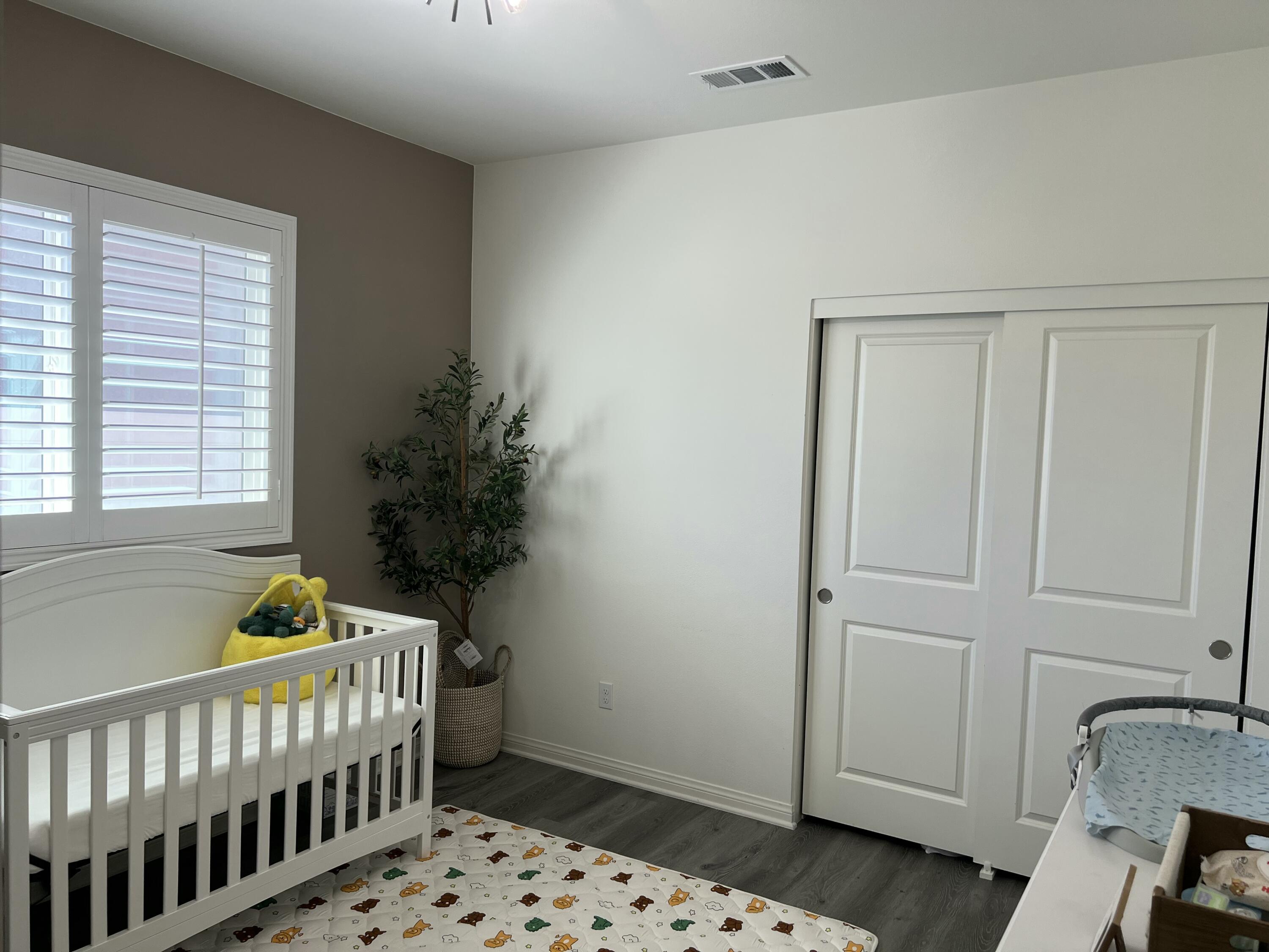 426 East Orchard Street Rialto, CA 92376 - Photo 15 of 18 a room with baby crib and dresser