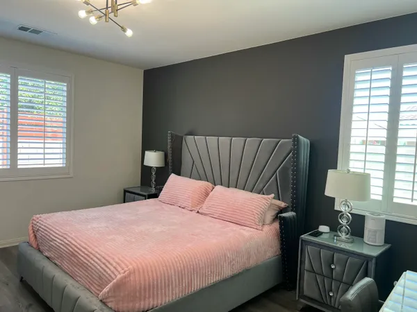 a bedroom with a bed and window