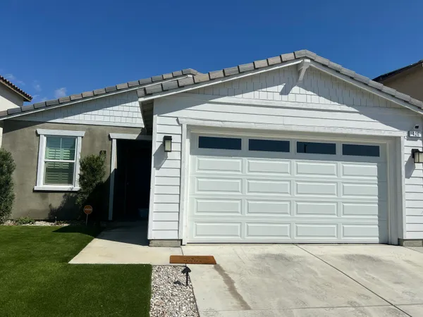a front view of a house with a yard