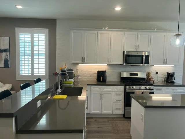 a kitchen with a stove a sink and a microwave