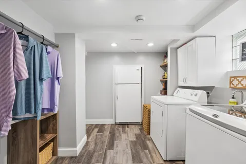 a view of a kitchen with refrigerator and wooden floor