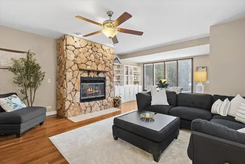 a living room with furniture a fireplace with wooden floor