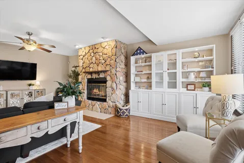 a living room with furniture a flat screen tv and a fireplace