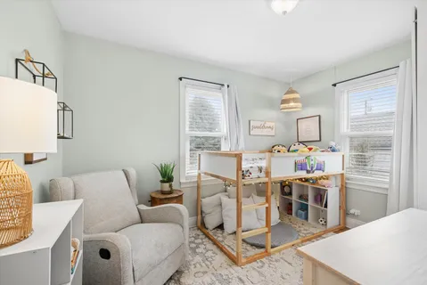 a living room with furniture a dining table and a table